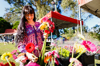 Lady shopping for flowers at Ballina Farmers Market