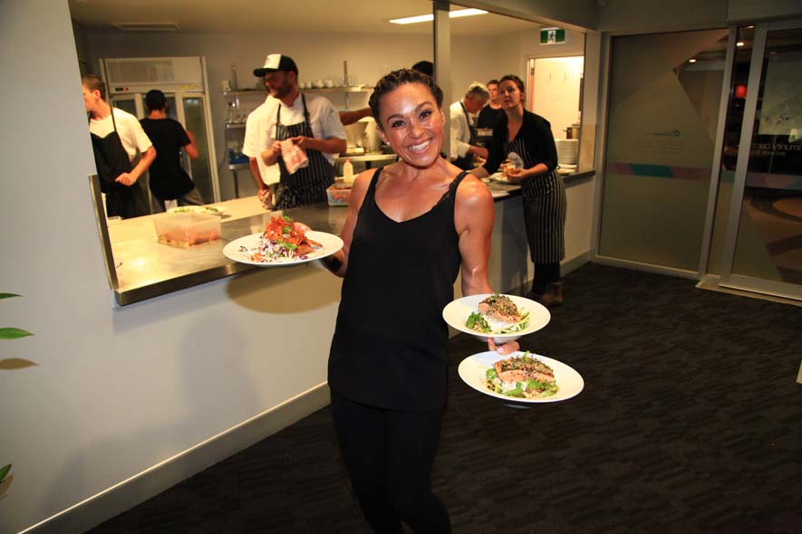 Waitress holding three plates ready to serve