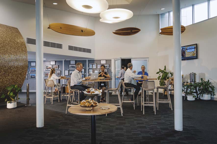 People mingling at tables in foyer