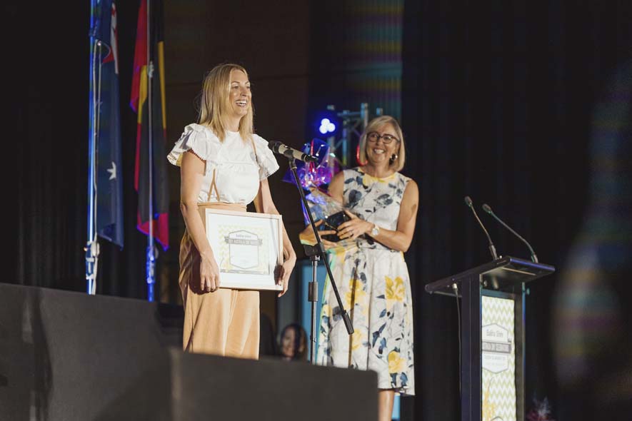 Speaker at conference on stage accepting an award