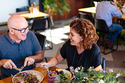 Couple laughing eating lunch at Belle Central