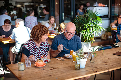 Couple at Belle Central eating cake & coffee