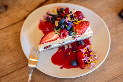 Yummy cake covered in fresh berries