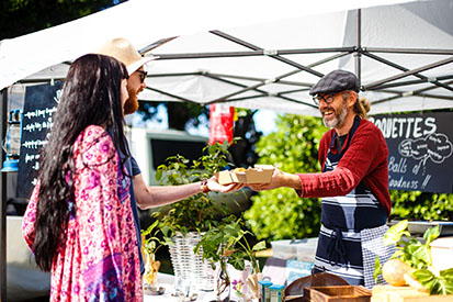 Couple being served food at Ballina Farmers Market 
