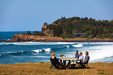 People sitting at table on headland