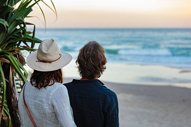 Back of couple enjoying the beach view