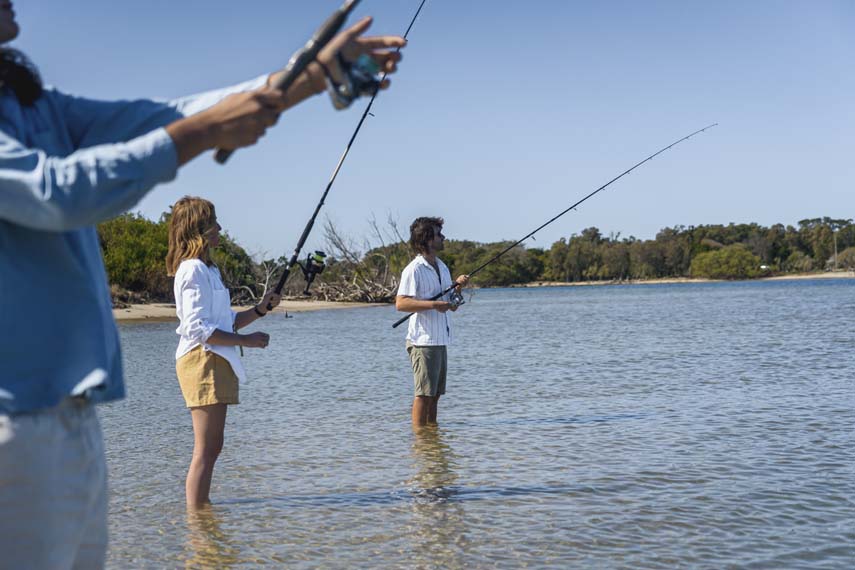 Island Life 4 - 3 people standing in river fishing