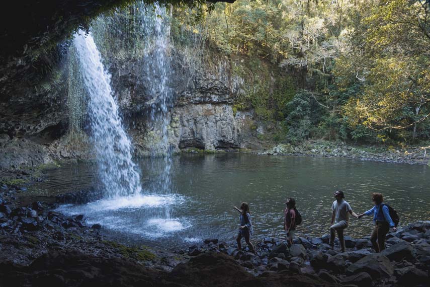 Killen Falls 1 Waterfall Northern Rivers with 4 people walking underneath