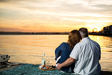Couple watching sunset at Lance Ferris Wharf 