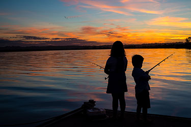 Kids fishing silhouette on Lance Ferris Wharf 