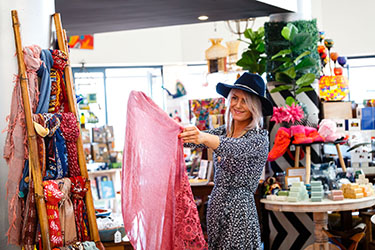 Lady looking at clothing in Lennox Head shop