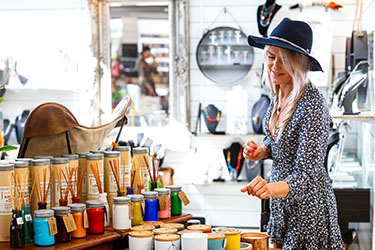 Lady looking at candles in shop