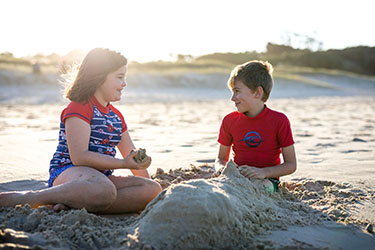 Boy and girl playing in sand