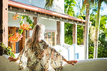 Lady looking out on Montanna balcony