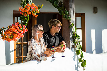 Couple on white balcony looking outwards