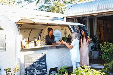 Ladies being served coffee at van