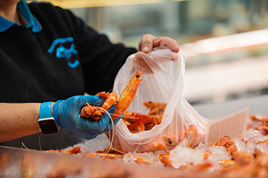 Lady bagging fresh prawns