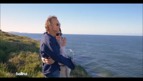 Couple hugging on coastal cliff