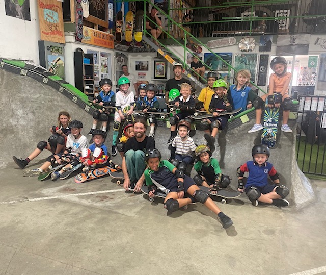 Truckstop Sk8 - Learn to skateboard kids sitting in skate bowl Ballina