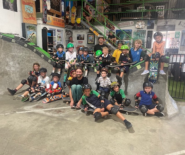 Truckstop Sk8 - Learn to skateboard kids sitting in skate bowl Ballina