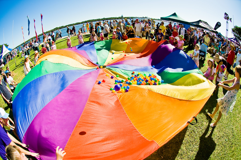 People at an event with rainbow coloured sheet