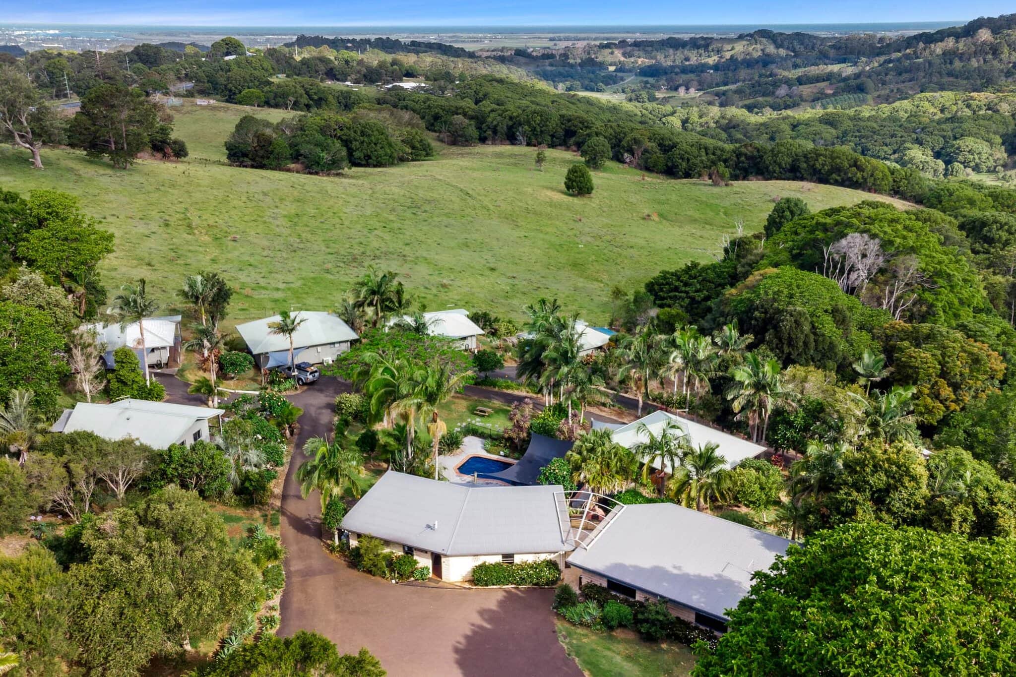 Alstonville Country Cottages – A Tranquil Hinterland Retreat Aerial view of Alstonville Country Cottages nestled in lush green hinterland with sweeping valley views