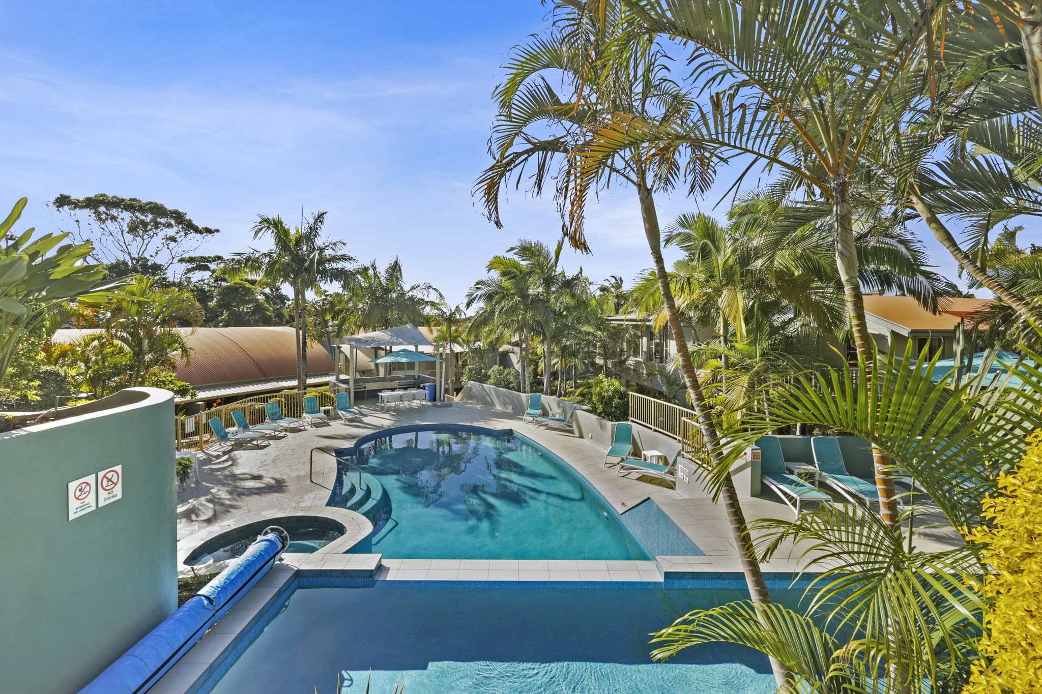 Lennox Beach Resort – Relaxed Tropical Poolside Accommodation in Coastal NSW Tropical resort-style pool surrounded by palm trees at Lennox Beach Resort in Lennox Head NSW