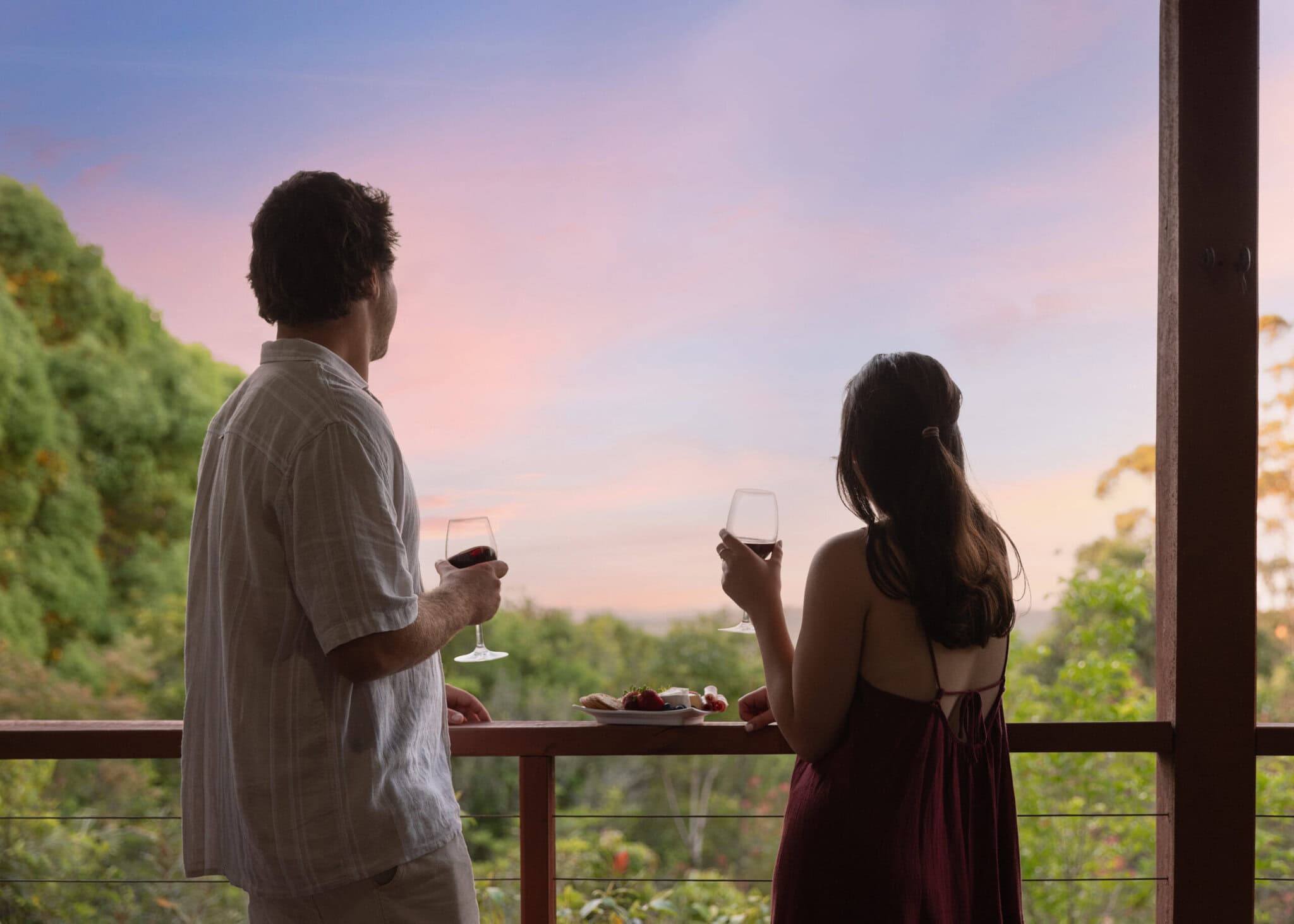 Couple enjoying sunset drinks on the verandah at Tallaringa Views hinterland accommodation in the Ballina Coast & Hinterland.