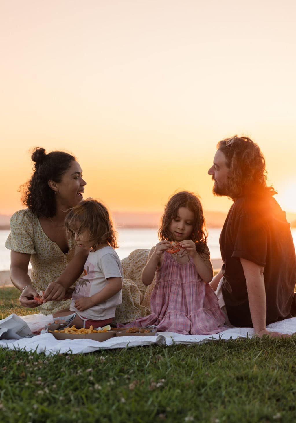 Riverfront Dining in Ballina Family dining on riverfront with sunset in background