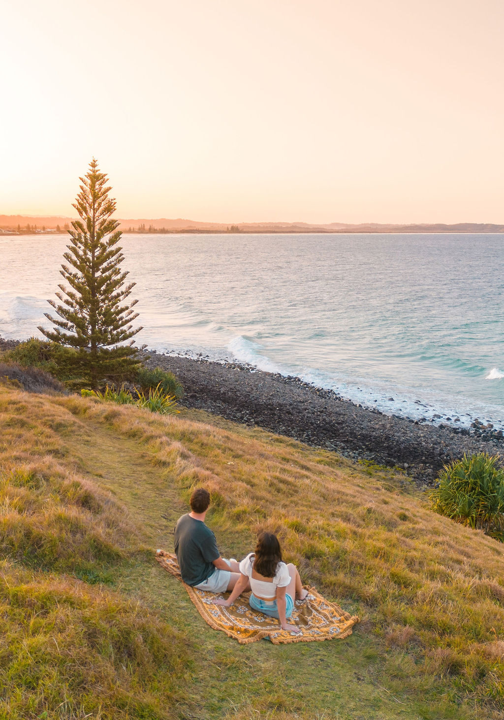 Couple sitting on Lennox Headland